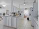 Bright kitchen features white cabinets, tiled floors, and an open layout leading to the dining area at 4622 Secret River Trl, Port Orange, FL 32129