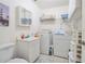 Bright laundry room equipped with a washing machine, dryer, and storage shelves for convenience at 4622 Secret River Trl, Port Orange, FL 32129