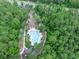An aerial view of a community pool surrounded by palm trees, with clear blue water at 5 Cantilever Ct, Ormond Beach, FL 32174