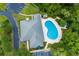 Aerial view of a community pool and clubhouse with lounge chairs, landscaping and parking area at 5 Cantilever Ct, Ormond Beach, FL 32174