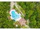 Aerial view of a beautiful community pool and clubhouse surrounded by mature trees and landscaping at 5 Cantilever Ct, Ormond Beach, FL 32174