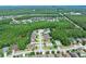 Scenic aerial view of homes in a community surrounded by beautiful mature trees and a tranquil lake at 5 Cantilever Ct, Ormond Beach, FL 32174