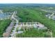 Gorgeous aerial view of homes in a neighborhood with mature trees, a pond, and winding roads at 5 Cantilever Ct, Ormond Beach, FL 32174
