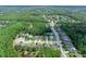 Overhead view of a community surrounded by lush greenery, featuring well-maintained homes and roads at 5 Cantilever Ct, Ormond Beach, FL 32174