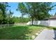 Expansive backyard offering a serene view, lush green grass, and a white fence for privacy at 5 Cantilever Ct, Ormond Beach, FL 32174