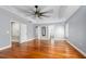 Expansive bedroom featuring hardwood floors, a tray ceiling, and abundant natural light at 5 Cantilever Ct, Ormond Beach, FL 32174