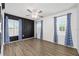 Bright bedroom with hardwood floors, two windows, and stylish blue patterned curtains at 5 Cantilever Ct, Ormond Beach, FL 32174