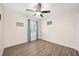 Cozy bedroom with warm wood-look flooring, a ceiling fan, and bright natural light at 5 Cantilever Ct, Ormond Beach, FL 32174