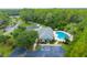Exterior view of a clubhouse with a pool, parking area, landscaping, and a beautiful setting at 5 Cantilever Ct, Ormond Beach, FL 32174