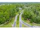 View of a community entrance featuring lush landscaping, mature trees, and well-maintained roads at 5 Cantilever Ct, Ormond Beach, FL 32174