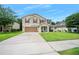 Well-maintained two-story home with a spacious front yard, two-car garage, and covered front porch at 5 Cantilever Ct, Ormond Beach, FL 32174