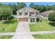 Charming two-story home with a well-manicured lawn, attached garage and welcoming front porch at 5 Cantilever Ct, Ormond Beach, FL 32174