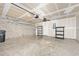 Unfinished garage with concrete floors, plenty of storage, and cinder block wall at 5 Cantilever Ct, Ormond Beach, FL 32174