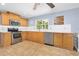 Well-equipped kitchen with stainless steel appliances, wood cabinets, and a tile backsplash at 5 Cantilever Ct, Ormond Beach, FL 32174