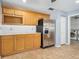 Kitchen with stainless steel refrigerator, light wood cabinets, and tile flooring at 5 Cantilever Ct, Ormond Beach, FL 32174