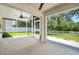 Enclosed lanai with ceiling fan overlooking a lush, green backyard at 5 Cantilever Ct, Ormond Beach, FL 32174
