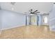 Spacious living room featuring tile flooring, a ceiling fan, and a bright front entrance at 5 Cantilever Ct, Ormond Beach, FL 32174