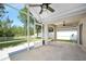 A covered patio with ceiling fans offers a relaxing outdoor living space overlooking the landscaped backyard at 5 Cantilever Ct, Ormond Beach, FL 32174
