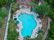 Aerial view of the community pool with plenty of lounge chairs and umbrellas for residents to enjoy at 5 Cantilever Ct, Ormond Beach, FL 32174