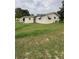 Exterior shot showcasing the side of the house and a spacious yard at 9393 Sw 102Nd Pl, Ocala, FL 34481