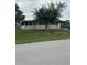 Charming home featuring a well-maintained front yard and inviting curb appeal with lovely green grass and mature trees at 9393 Sw 102Nd Pl, Ocala, FL 34481