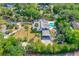 Aerial view of a beautiful property featuring a pool, a carport, and lush landscaping at 1159 Magnolia Ave, Daytona Beach, FL 32114