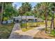 Aerial view of a landscaped property with a long driveway lined with mature palm trees at 1159 Magnolia Ave, Daytona Beach, FL 32114