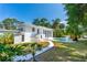 Spacious backyard features a pool, lush landscaping, and a charming two-story home at 1159 Magnolia Ave, Daytona Beach, FL 32114