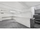 This basement has painted concrete floors and walls, built-in shelves and an exposed beam ceiling at 1159 Magnolia Ave, Daytona Beach, FL 32114