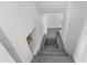 This basement stairway has painted concrete steps and walls for a minimalist aesthetic at 1159 Magnolia Ave, Daytona Beach, FL 32114