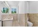 Bathroom features a double sink vanity, a walk-in shower and natural light from the window at 1159 Magnolia Ave, Daytona Beach, FL 32114