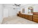 The spacious bedroom has a ceiling fan, carpet, natural light and built-in wood cabinets at 1159 Magnolia Ave, Daytona Beach, FL 32114