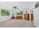 Bright bedroom with carpeted floor, ceiling fan, and view of the landscaping at 1159 Magnolia Ave, Daytona Beach, FL 32114