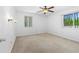 A serene bedroom has carpet, 3 windows, sconce lighting, and a ceiling fan at 1159 Magnolia Ave, Daytona Beach, FL 32114