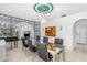 Bright dining room with a glass table, chairs, an arched entry to the living room, and an adjacent kitchen at 1159 Magnolia Ave, Daytona Beach, FL 32114