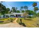 Inviting single-story home featuring a well-manicured lawn and charming front porch at 1159 Magnolia Ave, Daytona Beach, FL 32114