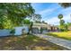 Charming single-story home with a decorative gate and a lush, landscaped front yard at 1159 Magnolia Ave, Daytona Beach, FL 32114