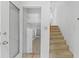 Hallway with tile floor leading to carpeted stairs at 1159 Magnolia Ave, Daytona Beach, FL 32114