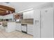 Well-lit kitchen with white cabinets and appliances and a breakfast nook near the sink at 1159 Magnolia Ave, Daytona Beach, FL 32114