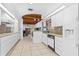 Functional kitchen with white appliances, ample cabinet space, and a cozy breakfast nook with wood beam ceiling at 1159 Magnolia Ave, Daytona Beach, FL 32114