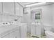 Laundry room with washer, dryer, sink and cabinets at 1159 Magnolia Ave, Daytona Beach, FL 32114