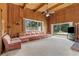 Cozy living room with wood paneling, brick fireplace, and sliding glass doors to the backyard at 1159 Magnolia Ave, Daytona Beach, FL 32114