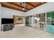 Open living room with wood-paneled ceiling and access to the outdoor patio at 1159 Magnolia Ave, Daytona Beach, FL 32114