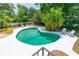 An inviting backyard pool surrounded by lush greenery offers a serene escape at 1159 Magnolia Ave, Daytona Beach, FL 32114