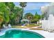 Backyard pool featuring a gazebo with outdoor seating, lush landscaping and lawn area at 1159 Magnolia Ave, Daytona Beach, FL 32114