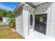 Enclosed side entry features a security gate and traditional door at 1159 Magnolia Ave, Daytona Beach, FL 32114