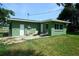 Green house with large backyard and patio at 1301 Oakwood Ave, Daytona Beach, FL 32114
