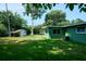 Green house with large backyard and shed at 1301 Oakwood Ave, Daytona Beach, FL 32114