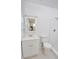 All-white bathroom featuring a modern vanity, toilet, and shower with bright natural light at 1301 Oakwood Ave, Daytona Beach, FL 32114