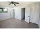Bright bedroom featuring hardwood floors, ceiling fan, natural light, and a closet for ample storage at 1301 Oakwood Ave, Daytona Beach, FL 32114